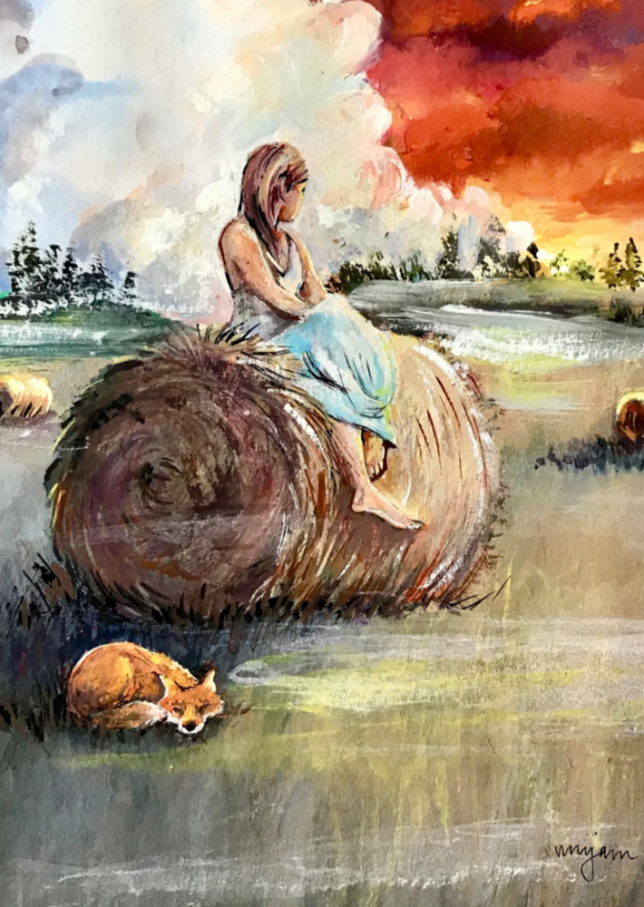 A woman sat on a hay bale, a fox curled up beneath her